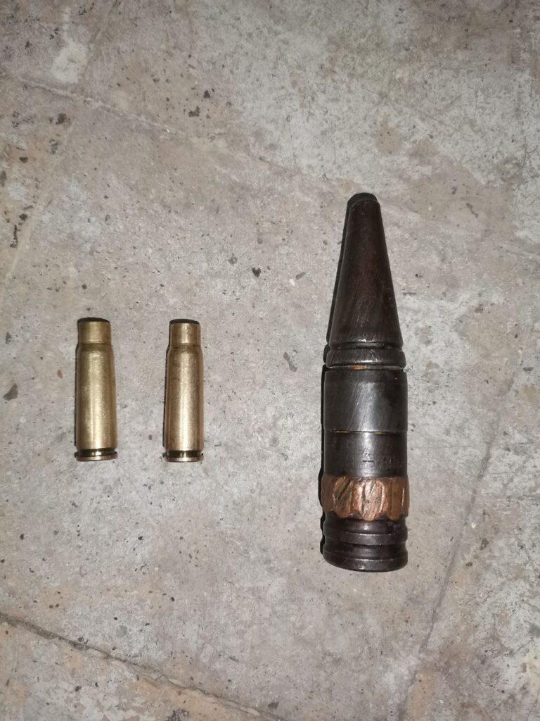 Left: Two 7.62x39mm casings ( likely from AK-style automatic rifles ). Right: 37mm round, likely a WWII-era 37mm BR-167 anti-aircraft kinetic tracer round from Soviet Factory 12 ( per its markings ). 